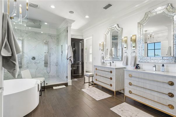 Bathroom, Dual Sink Vanities, Free Standing Baths, Glass Shower, Interior, Marble Walls, Recessed Lighting, Wood Texture Flooring
