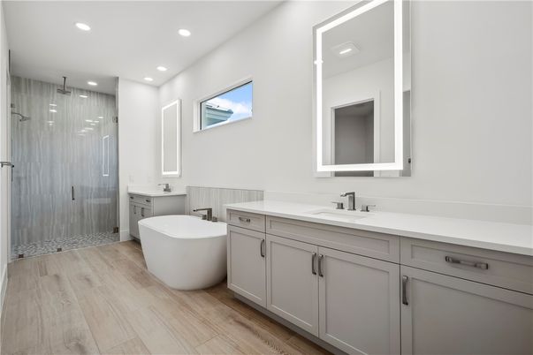 Bathroom, Dual Sink Vanities, Free Standing Baths, Glass Shower, Interior, Recessed Lighting, Wood Texture Flooring