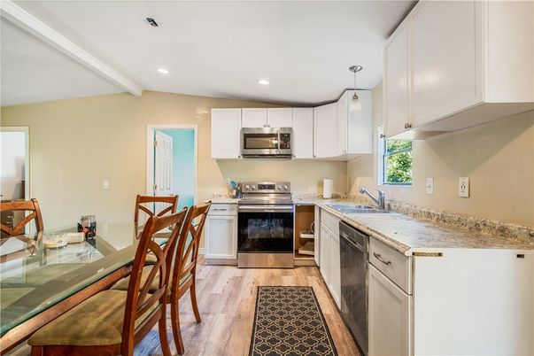 Dining room, Interior, Kitchen, Pendant Lights, Recessed Lighting, Stainless Steel Appliances, Wood Texture Flooring