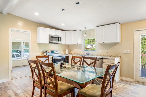 Dining room, Interior, Kitchen, Pendant Lights, Recessed Lighting, Stainless Steel Appliances, Wood Texture Flooring