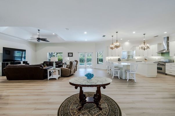 Chandelier, Dining room, Interior, Kitchen, Living room, Pendant Lights, Recessed Lighting, Stainless Steel Appliances, Wood Texture Flooring