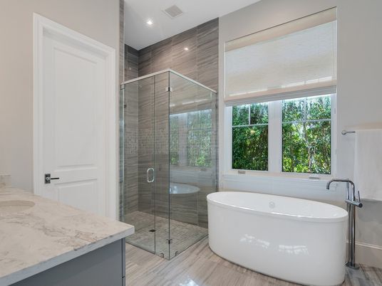 Bathroom, Free Standing Baths, Glass Shower, Interior, Marble Walls, Recessed Lighting, Wood Texture Flooring