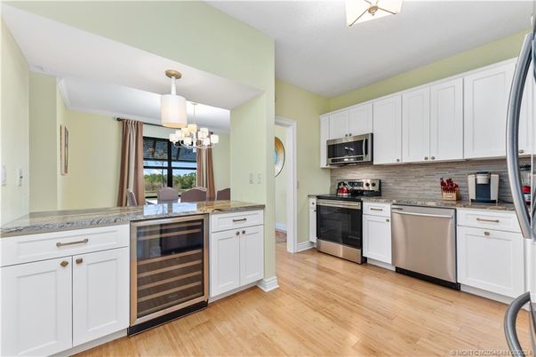 Chandelier, Dining room, Interior, Kitchen, Pendant Lights, Stainless Steel Appliances, Wood Texture Flooring