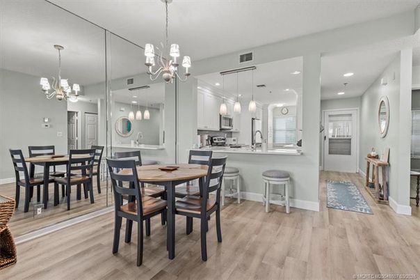 Chandelier, Dining room, Interior, Kitchen, Pendant Lights, Recessed Lighting, Stainless Steel Appliances, Wood Texture Flooring