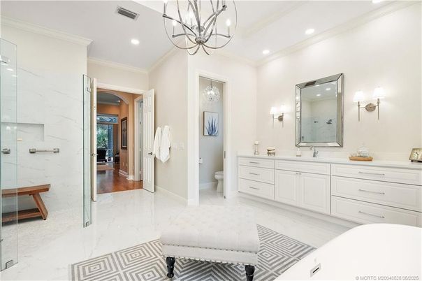 Bathroom, Dual Sink Vanities, Glass Shower, Interior, Marble, Marble Walls, Pendant Lights, Recessed Lighting, Wood Texture Flooring
