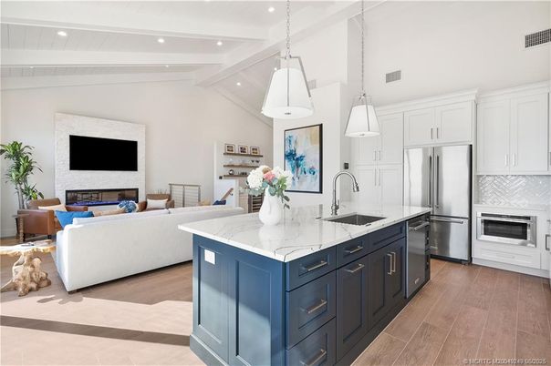Fireplace, Interior, Kitchen, Living room, Pendant Lights, Recessed Lighting, Stainless Steel Appliances, Wood Texture Flooring