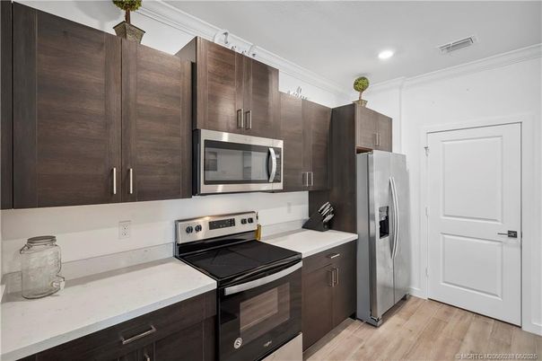 Interior, Kitchen, Recessed Lighting, Stainless Steel Appliances, Washer, Wood Texture Flooring