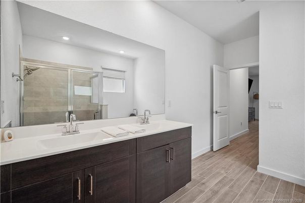 Bathroom, Dual Sink Vanities, Glass Shower, Interior, Recessed Lighting, Wood Texture Flooring