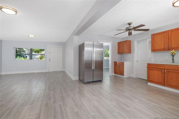 Empty room, Interior, Kitchen, Recessed Lighting, Stainless Steel Appliances, Wood Texture Flooring