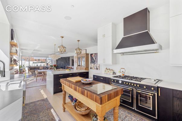Chandelier, Dining room, Interior, Kitchen, Living room, Pendant Lights, Recessed Lighting, Stainless Steel Appliances, Wood Texture Flooring