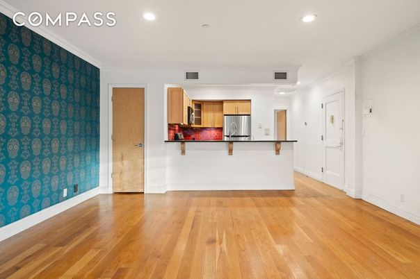 Empty room, Interior, Kitchen, Recessed Lighting, Stainless Steel Appliances, Wood Texture Flooring