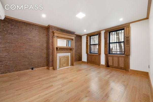 Empty room, Fireplace, Interior, Recessed Lighting, Stone Walls, Wood Texture Flooring