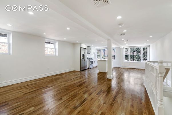 Empty room, Interior, Kitchen, Recessed Lighting, Stainless Steel Appliances, Wood Texture Flooring