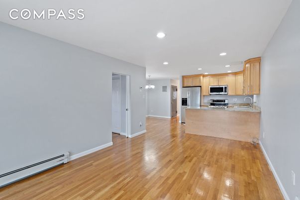 Empty room, Interior, Kitchen, Recessed Lighting, Stainless Steel Appliances, Wood Texture Flooring