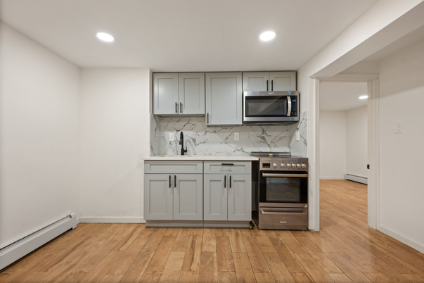 Interior, Kitchen, Marble Walls, Recessed Lighting, Stainless Steel Appliances, Wood Texture Flooring