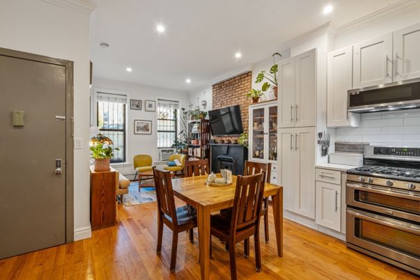 Dining room, Fireplace, Interior, Kitchen, Recessed Lighting, Stainless Steel Appliances, Stone Walls, Wood Texture Flooring