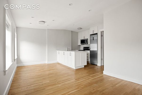 Empty room, Interior, Kitchen, Recessed Lighting, Stainless Steel Appliances, Wood Texture Flooring