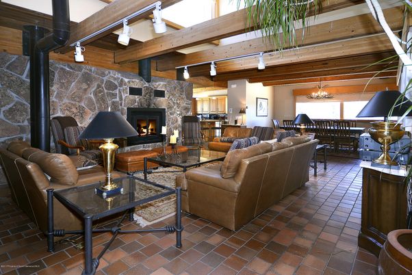 Chandelier, Dining room, Fireplace, Interior, Living room, Stone Walls, Wooden Beams