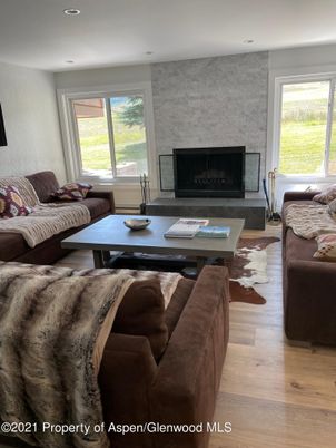 Fireplace, Interior, Living room, Recessed Lighting, Stone Walls, Wood Texture Flooring