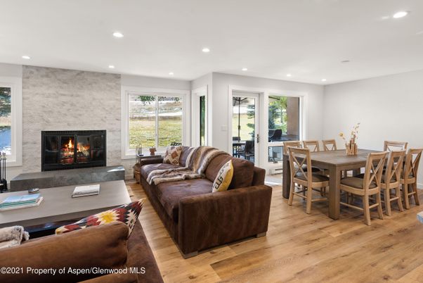 Dining room, Fireplace, Interior, Living room, Recessed Lighting, Stone Walls, Wood Texture Flooring