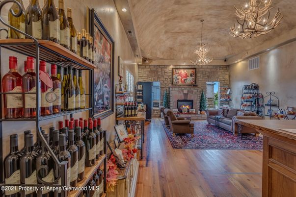 Chandelier, Fireplace, Interior, Living room, Recessed Lighting, Stone Walls, Wood Texture Flooring