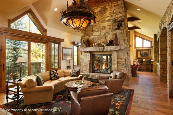 Chandelier, Fireplace, Interior, Living room, Recessed Lighting, Stone Walls, Wood Texture Flooring