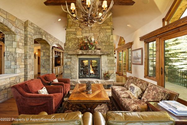 Chandelier, Fireplace, Interior, Living room, Recessed Lighting, Stone Walls, Wooden Beams, Wood Texture Flooring