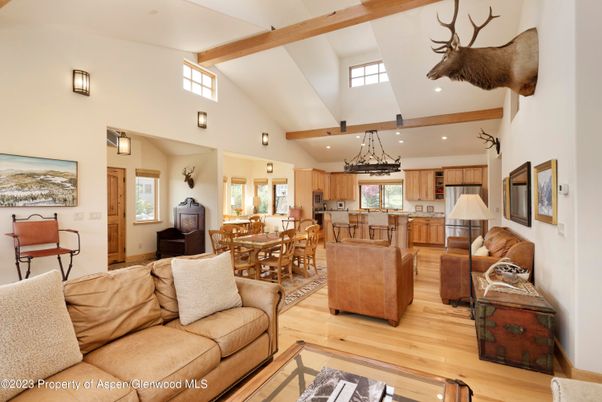 Chandelier, Dining room, Interior, Kitchen, Living room, Pendant Lights, Recessed Lighting, Stainless Steel Appliances, Wooden Beams, Wood Texture Flooring