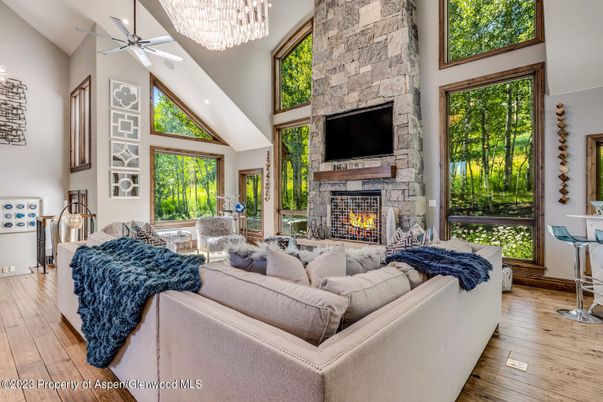 Chandelier, Fireplace, Interior, Living room, Stone Walls, Wood Texture Flooring