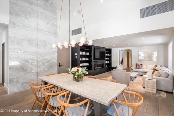 Dining room, Fireplace, Interior, Living room, Marble Walls, Pendant Lights, Recessed Lighting, Wood Texture Flooring