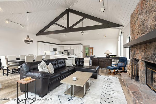 Chandelier, Dining room, Fireplace, Interior, Kitchen, Living room, Pendant Lights, Recessed Lighting, Stone Walls, Wooden Beams, Wood Texture Flooring
