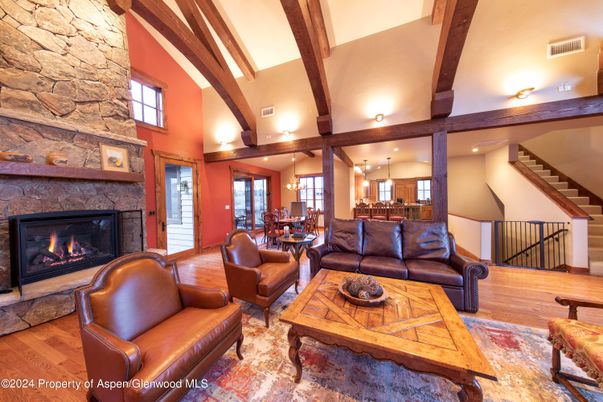 Dining room, Fireplace, Interior, Living room, Pendant Lights, Recessed Lighting, Stone Walls, Wooden Beams, Wood Texture Flooring