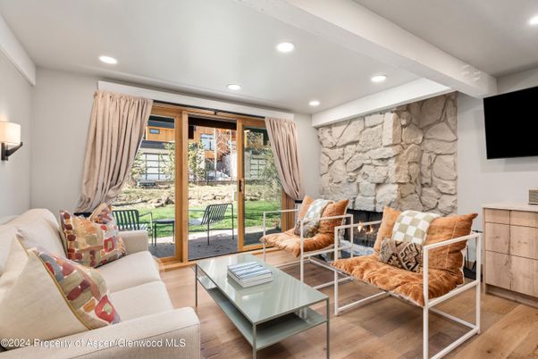 Fireplace, Interior, Living room, Recessed Lighting, Stone Walls, Wood Texture Flooring