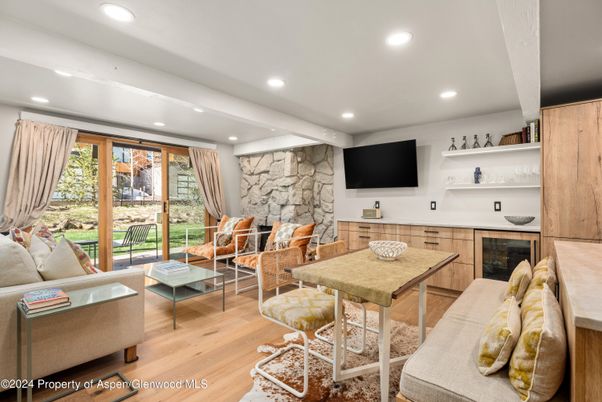 Fireplace, Interior, Living room, Recessed Lighting, Stone Walls, Wood Texture Flooring