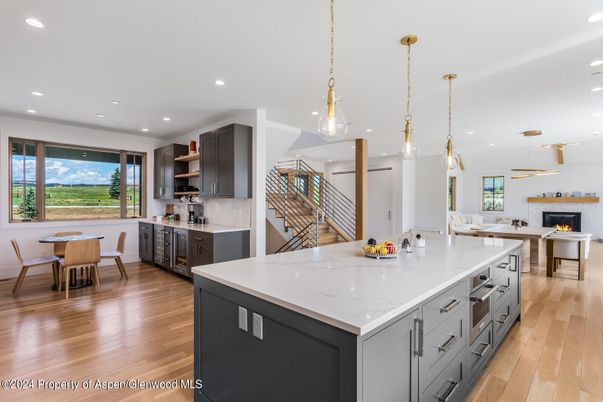 Dining room, Fireplace, Interior, Kitchen, Pendant Lights, Recessed Lighting, Stainless Steel Appliances, Wood Texture Flooring