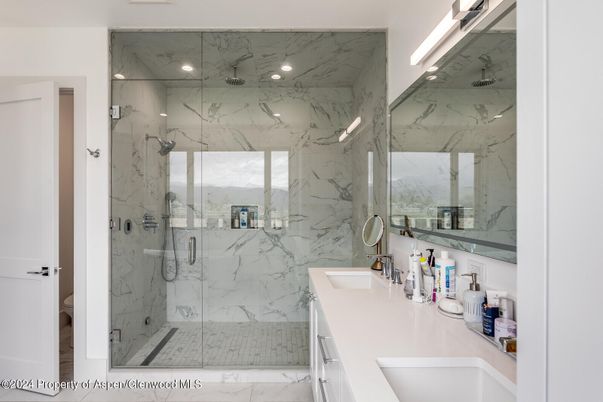 Bathroom, Dual Sink Vanities, Glass Shower, Interior, Marble, Marble Walls, Recessed Lighting