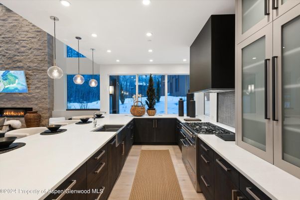 Fireplace, Interior, Kitchen, Pendant Lights, Recessed Lighting, Stainless Steel Appliances, Stone Walls, Wood Texture Flooring