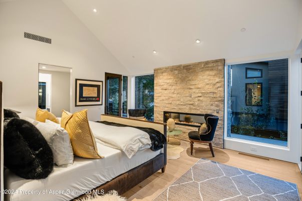 Bedroom, Fireplace, Interior, Recessed Lighting, Stone Walls, Wood Texture Flooring