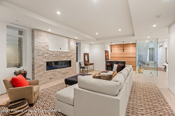 Fireplace, Interior, Living room, Recessed Lighting, Stone Walls, Wood Texture Flooring, Wooden Walls