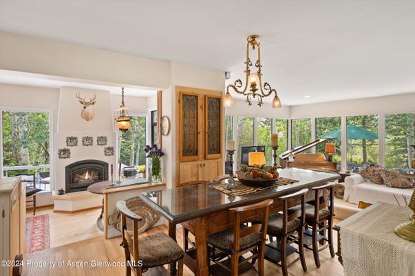 Chandelier, Dining room, Fireplace, Interior, Living room, Pendant Lights, Piano, Recessed Lighting, Wood Texture Flooring