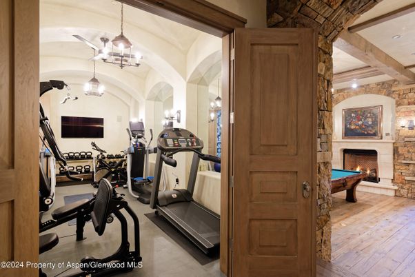 Billiard Table, Fireplace, Fitness Equipment, Game Room, Interior, Pendant Lights, Stone Walls, Wooden Beams, Wood Texture Flooring