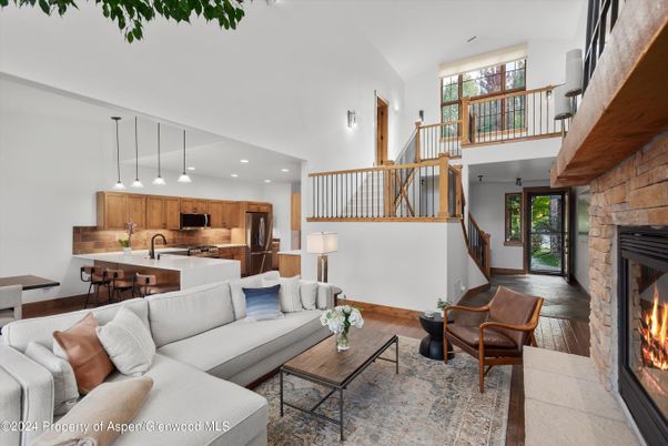 Fireplace, Interior, Kitchen, Living room, Pendant Lights, Recessed Lighting, Stainless Steel Appliances, Stone Walls, Wood Texture Flooring
