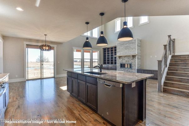 Fireplace, Interior, Kitchen, Pendant Lights, Recessed Lighting, Stainless Steel Appliances, Stone Walls, Wood Texture Flooring