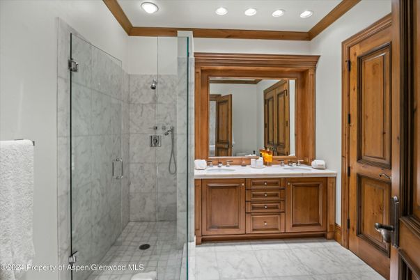 Bathroom, Dual Sink Vanities, Glass Shower, Interior, Marble, Marble Walls, Recessed Lighting