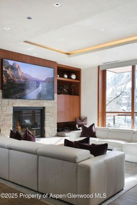 Fireplace, Interior, Living room, Recessed Lighting, Stone Walls, Wood Texture Flooring