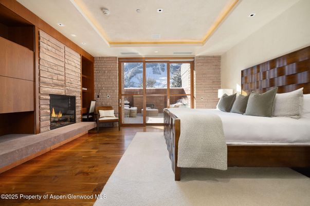 Bedroom, Fireplace, Interior, Recessed Lighting, Stone Walls, Wood Texture Flooring
