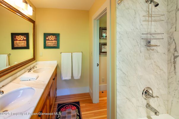 Bathroom, Dual Sink Vanities, Interior, Marble Walls, Wood Texture Flooring