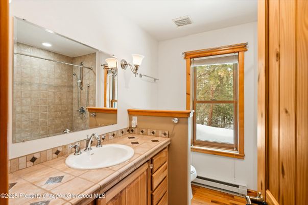Bathroom, Interior, Recessed Lighting, Tile Countertops, Wood Texture Flooring