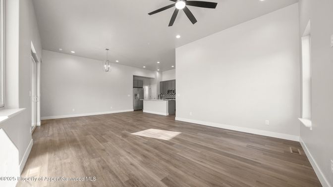 Empty room, Interior, Kitchen, Pendant Lights, Recessed Lighting, Stainless Steel Appliances, Wood Texture Flooring