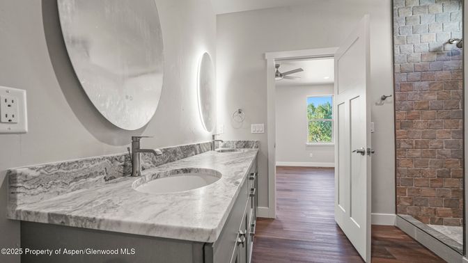 Bathroom, Dual Sink Vanities, Interior, Recessed Lighting, Stone Walls, Wood Texture Flooring